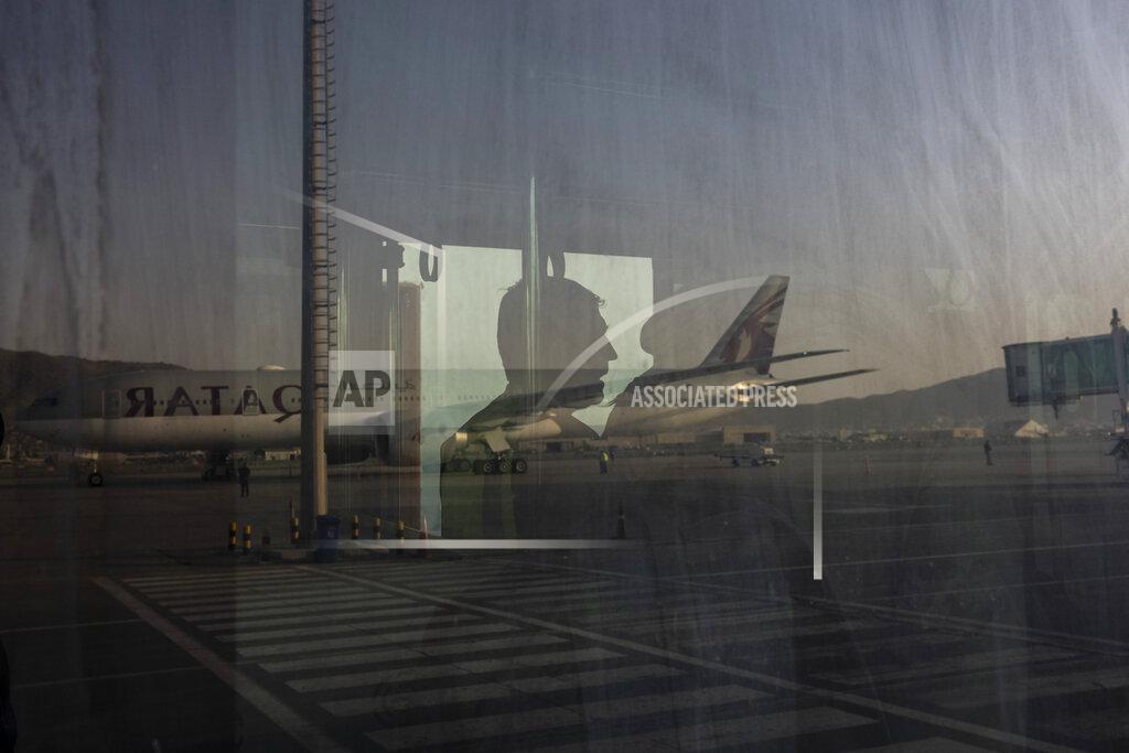 Bernat Armangue A Qatar Airways aircraft is reflected on a bus at the airport in Kabul, Afghanistan, Thursday, Sept. 9, 2021. Some 200 foreigners, including Americans, flew out of Afghanistan on an international commercial flight from Kabul airport on Thursday, the first such large-scale departure since U.S and foreign forces concluded their frantic withdrawal at the end of last month. (AP Photo/Bernat Armangue)