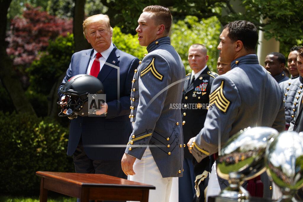 Evan Vucci President Donald Trump looks on as Army linebacker Cole Christiansen speaks during the presentation of the Commander-in-Chief's Trophy to the U.S. Military Academy at West Point football team, in the Rose Garden of the White House, Monday, May 6, 2019, in Washington. (AP Photo/Evan Vucci)