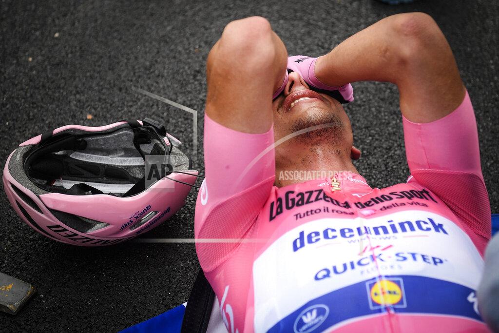 Massimo Paolone Race leader Portugal's Joao Almeida lies exhausted after concluding the 15th stage of the Giro d'Italia cycling race, from Rivolto to Piancavallo, Italy, Sunday, Oct. 18, 2020. (Massimo Paolone/LaPresse via AP)