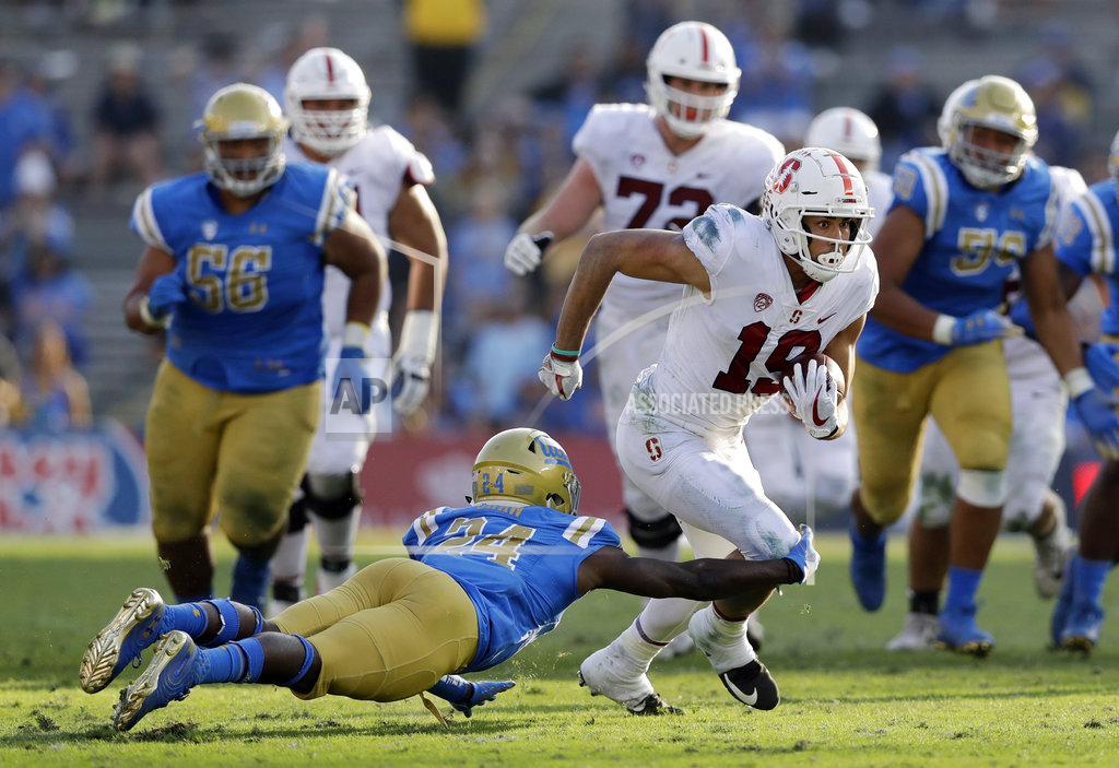 Marcio Jose Sanchez Stanford wide receiver JJ Arcega-Whiteside, right, runs after a reception as UCLA defensive back Jay Shaw, bottom left, attempts a tackle during the second half of an NCAA college football game Saturday, Nov. 24, 2018, in Pasadena, Calif. (AP Photo/Marcio Jose Sanchez)