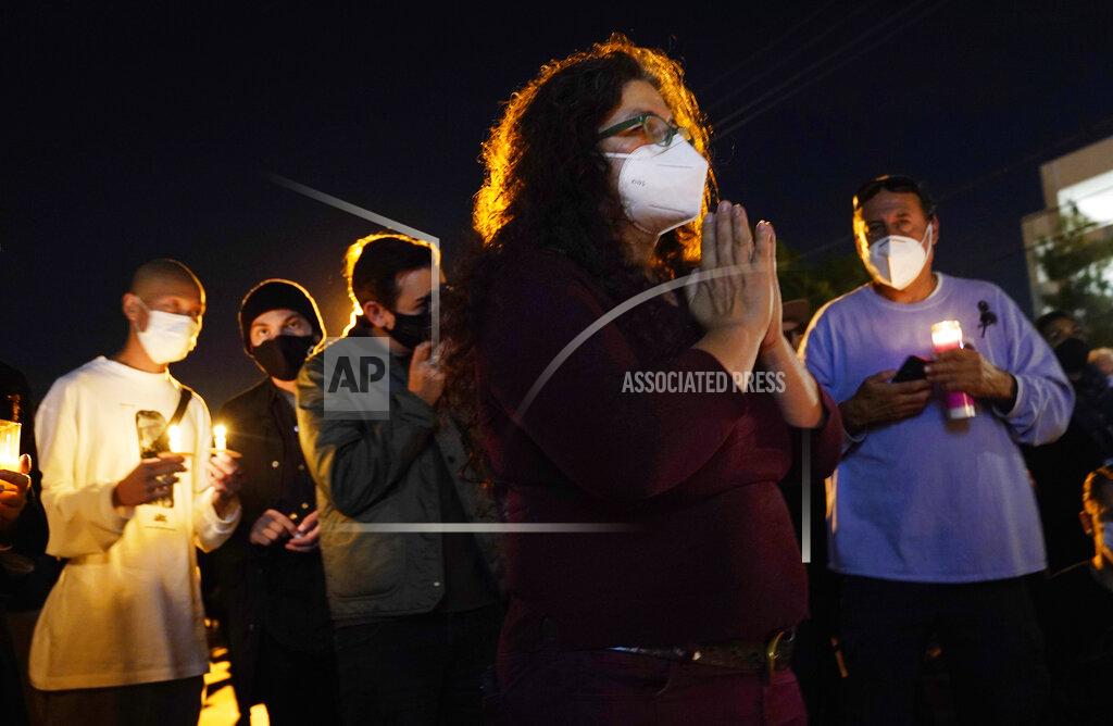 Chris Pizzello Lisa Walker, right, joins other attendees at a candlelight vigil for the late cinematographer Halyna Hutchins, Sunday, Oct. 24, 2021, in Burbank, Calif. A prop firearm discharged last Thursday by actor Alec Baldwin, while producing and starring in a Western movie in Santa Fe, N.M., killed Hutchins and wounded director Joel Souza. (AP Photo/Chris Pizzello)