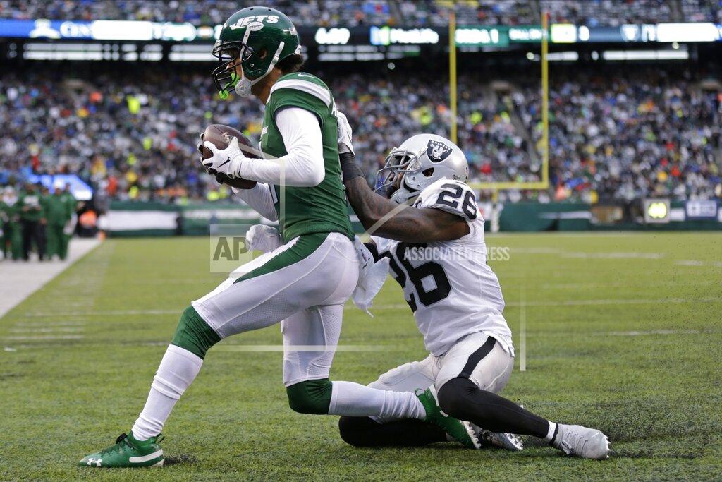 Adam Hunger Oakland Raiders cornerback Nevin Lawson (26) attempts to tackles New York Jets' Robby Anderson (11) after Anderson scored during the second half of an NFL football game Sunday, Nov. 24, 2019, in East Rutherford, N.J. (AP Photo/Adam Hunger)