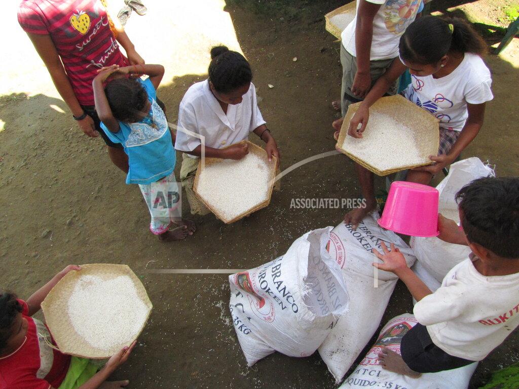 Uncredited This 2010 photo provided to The Associated Press shows children sifting rice at the Topu Honis children's shelter in Kutet, East Timor. (AP Photo)