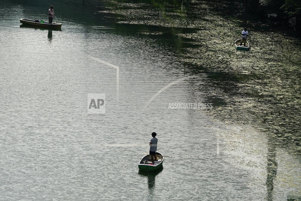 Jae C. Hong People fish in a moat ahead of the 2020 Summer Olympics on Thursday, July 15, 2021, in Tokyo. (AP Photo/Jae C. Hong)
