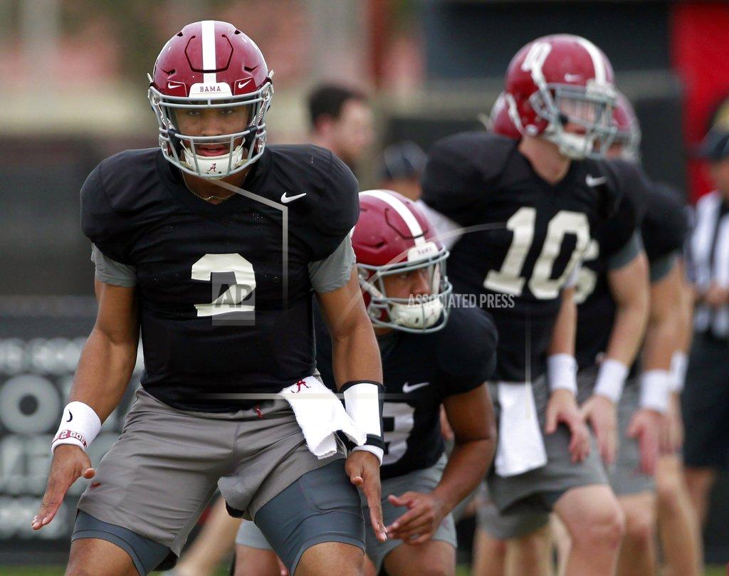Carl Juste Alabama quarterback Jalen Hurts, left, stretches along with others at NCAA college football practice in Miami Shores, Fla., Thursday, Dec. 27, 2018, for the Orange Bowl against Oklahoma on Dec. 29, 2018. (Carl Juste/Miami Herald via AP)
