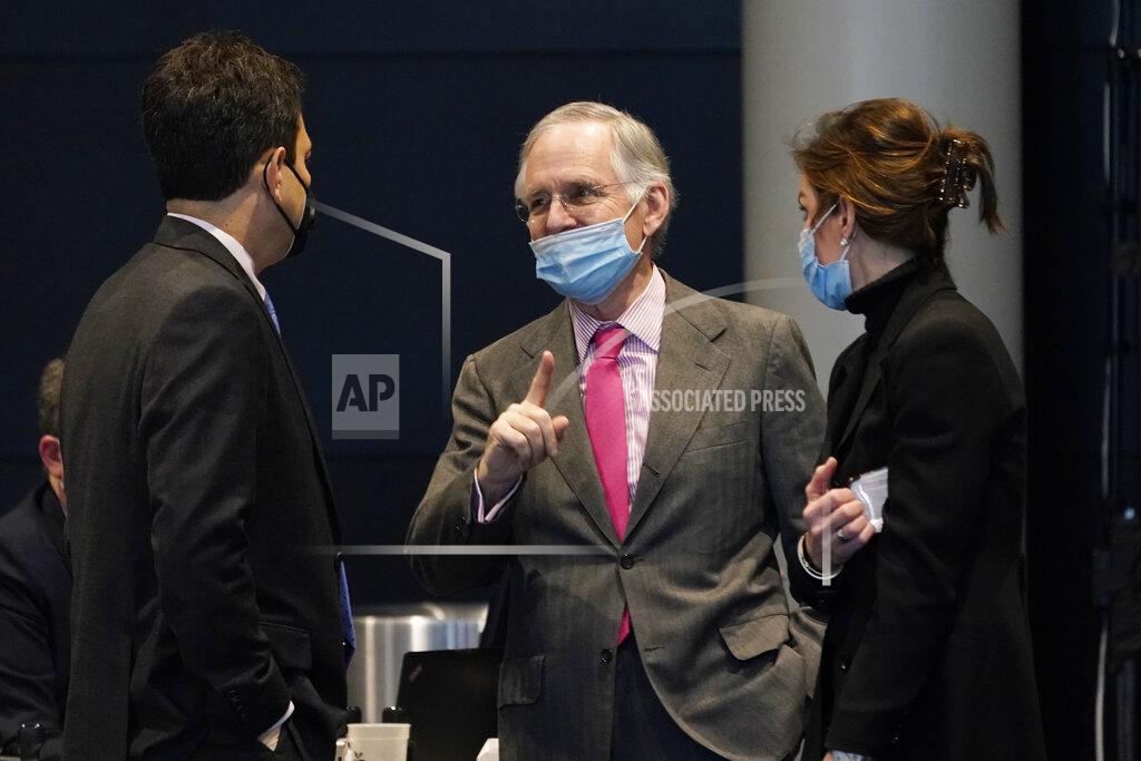 Steve Helber Virginia Senate minority leader, Sen. Thomas Norment, R-Jame City County, center, talks with Sen. Scott Surovell, D-Fairfax, left, and Sen. Jill Vogel, R-Fauquier, during the Senate session at the Science Museum in Richmond, Va., Wednesday, Feb. 17, 2021. (AP Photo/Steve Helber)