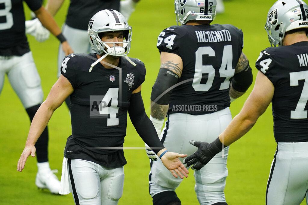John Locher Las Vegas Raiders quarterback Derek Carr (4) greets offensive tackle Kolton Miller, right, during an NFL football training camp practice Friday, Aug. 21, 2020, in Las Vegas. (AP Photo/John Locher)