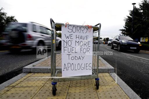 A sign referring to the lack of fuel is placed at the entrance to a petrol station in London, Tuesday, Sept. 28, 2021. Long lines of vehicles have formed at many gas stations around Britain since Friday, causing spillover traffic jams on busy roads. (AP Photo/Frank Augstein)