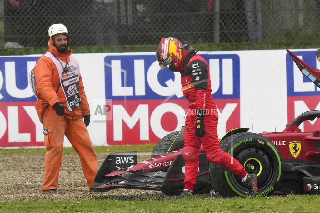 Luca Bruno Ferrari driver Carlos Sainz of Spain walks after crashing during the Emilia Romagna Formula One Grand Prix, at the Enzo and Dino Ferrari racetrack, in Imola, Italy, Sunday, April 24, 2022. (AP Photo/Luca Bruno)