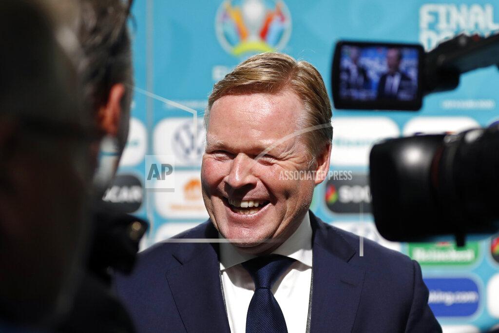 FILE- In this Nov. 30, 2019 file photo, soccer coach Ronald Koeman smiles while talking to journalists after the draw for the UEFA Euro 2020 soccer tournament finals in Bucharest, Romania. Barcelona officially announced on Wednesday Aug. 19, 2020a deal with Koeman to become their coach five days after the team's humiliating 8-2 loss to Bayern Munich in the Champions League quarterfinals. Barcelona says the former defender's deal runs through June 2022. Koeman replaces the fired Quique Setien.(AP Photo/Petr David Josek, File)