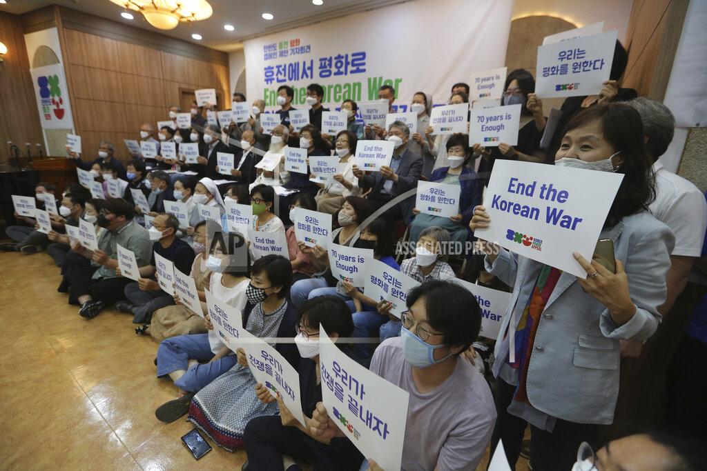 Anti-war activists hold cards after a press conference to demand the peace on the Korean peninsula on the eve of the 70th anniversary of the outbreak of the Korean War in Seoul, South Korea, Wednesday, June 24, 2020. North Korean leader Kim Jong Un suspended his military's plans to take unspecified retaliatory action against South Korea, state media said Wednesday, possibly slowing a pressure campaign against its rival amid stalled nuclear negotiations with the Trump administration. The sign reads "Let us end the war." (AP Photo/Ahn Young-joon)