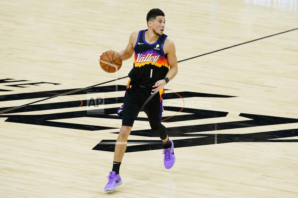 Matt York Phoenix Suns guard Devin Booker (1) dribbles against the Los Angeles Clippers during the first half of Game 2 of the NBA basketball Western Conference Finals, Tuesday, June 22, 2021, in Phoenix. (AP Photo/Matt York)