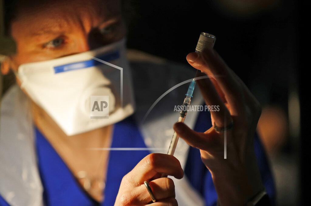 Frank Augstein Doctor Claire Chatt prepares the Pfizer-BioNTech vaccine inside Salisbury Cathedral in Salisbury, England, Wednesday, Jan. 20, 2021. Salisbury Cathedral opened its doors for the second time as a venue for the Sarum South Primary Care Network COVID-19 Local Vaccination Service. (AP Photo/Frank Augstein)