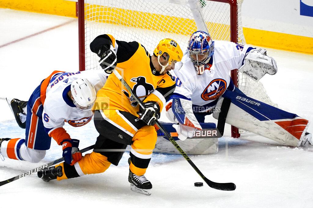 Gene J. Puskar Pittsburgh Penguins' Sidney Crosby, center, cannot get his stick on the puck in front of New York Islanders goaltender Ilya Sorokinin, right, with Islanders' Ryan Pulock (6) defending during the first period of Game 1 of an NHL hockey Stanley Cup first-round playoff series in Pittsburgh, Sunday, May 16, 2021. (AP Photo/Gene J. Puskar)