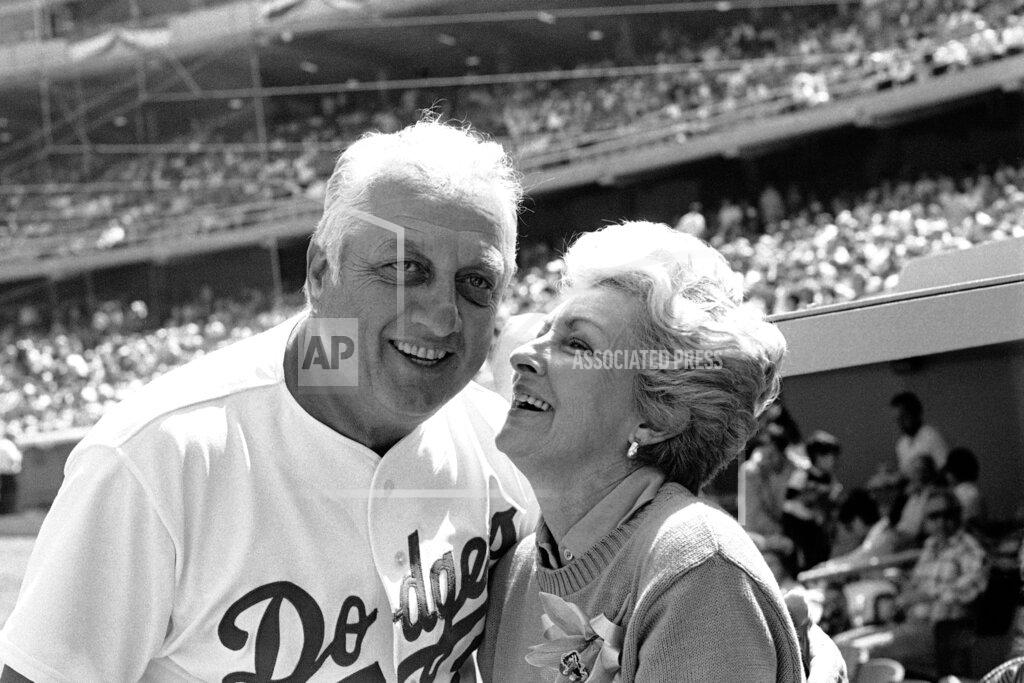 Lennox Mclendon FILE - Jo Lasorda, wife of Los Angeles Dodgers' manager Tommy Lasorda, leans up to give him a good luck kiss on the start of his 35th season with the Dodger organization, in Los Angeles in this April 4, 1984, file photo. Jo Lasorda has died. She was 91. She died Monday night, Sept. 20, 2021, at her home in Fullerton, the team said Tuesday. No cause of death was given. (AP Photo/Lennox Mclendon, File)