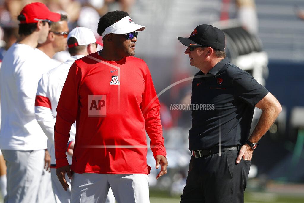 Rick Scuteri Arizona head coach Kevin Sumlin, left, and Oregon State head coach Jonathan Smith talk before an NCAA college football game, Saturday, Nov. 2, 2019, in Tucson, Ariz. (AP Photo/Rick Scuteri)