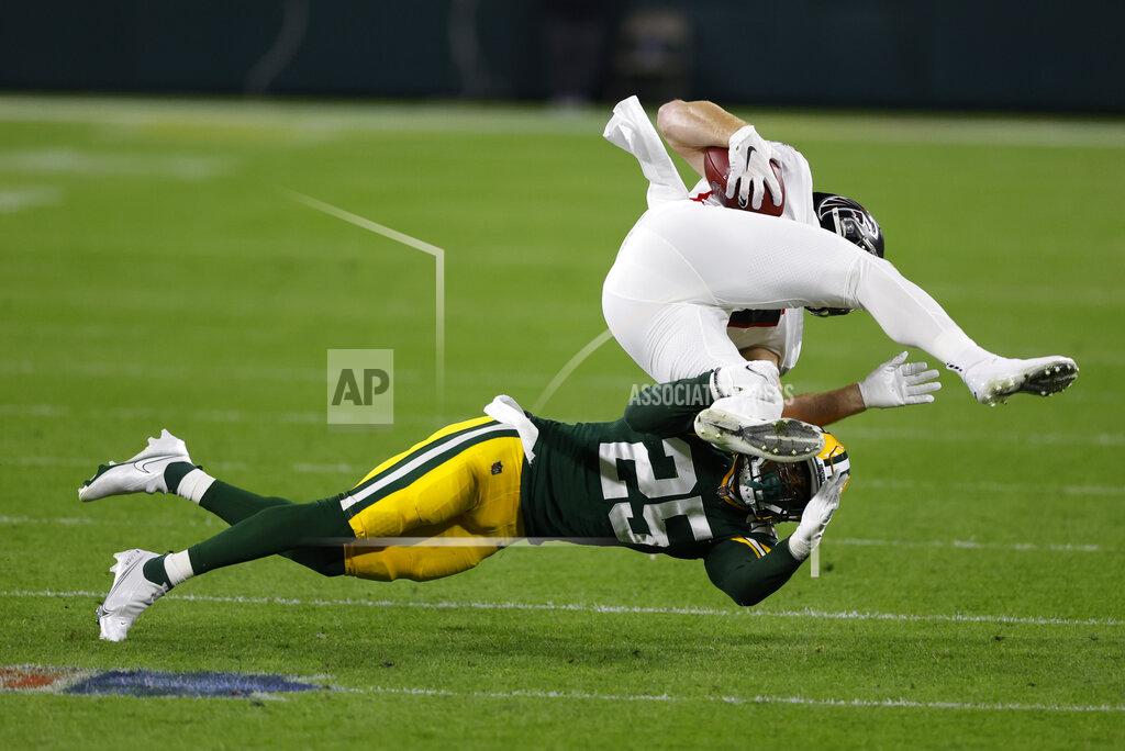 Tom Lynn Green Bay Packers' Will Redmond (25) tackles Atlanta Falcons' Hayden Hurst, top, during the first half of an NFL football game, Monday, Oct. 5, 2020, in Green Bay, Wis. (AP Photo/Tom Lynn)