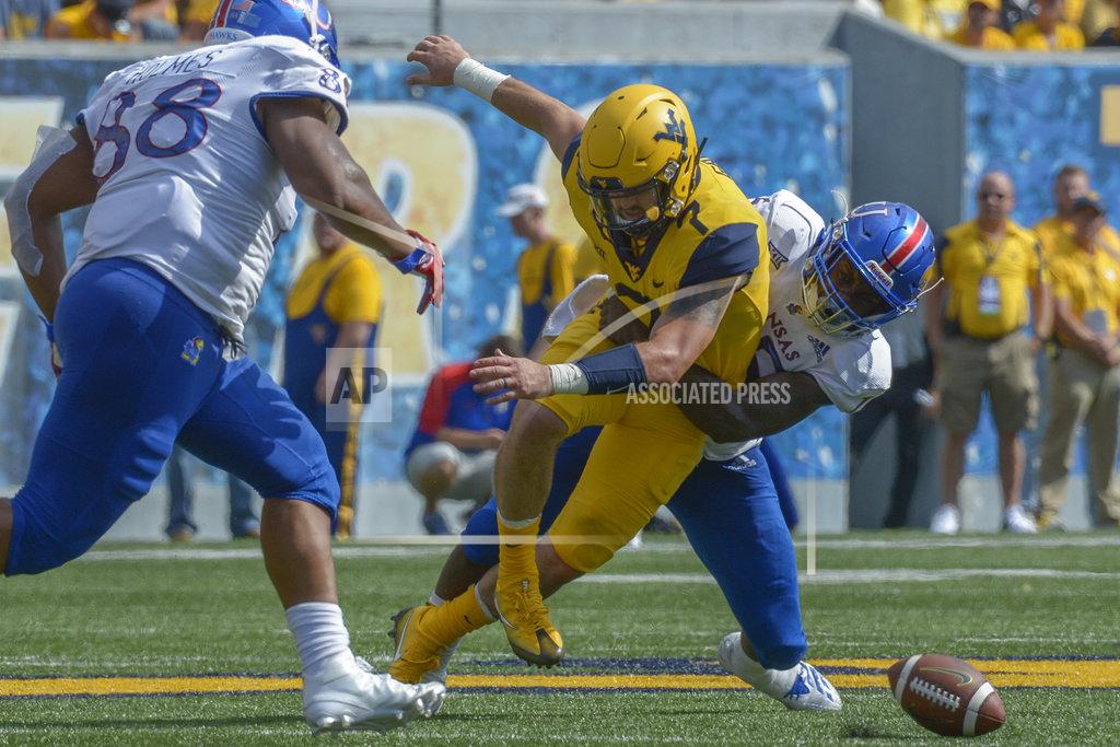 Craig Hudson West Virginia quarterback Will Grier (7) fumbles the ball against Kansas during the second half of an NCAA college football game in Morgantown, W. Va., Saturday Oct. 6, 2018. (Craig Hudson/Charleston Gazette-Mail via AP)