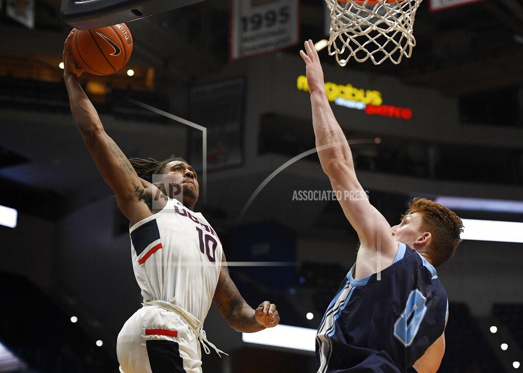 Jessica Hill Connecticut's Brendan Adams, left, lines up a dunk as Maine's Andrew Fleming, right, defends during the second half of an NCAA college basketball game, Sunday, Dec. 1, 2019, in Hartford, Conn. (AP Photo/Jessica Hill)