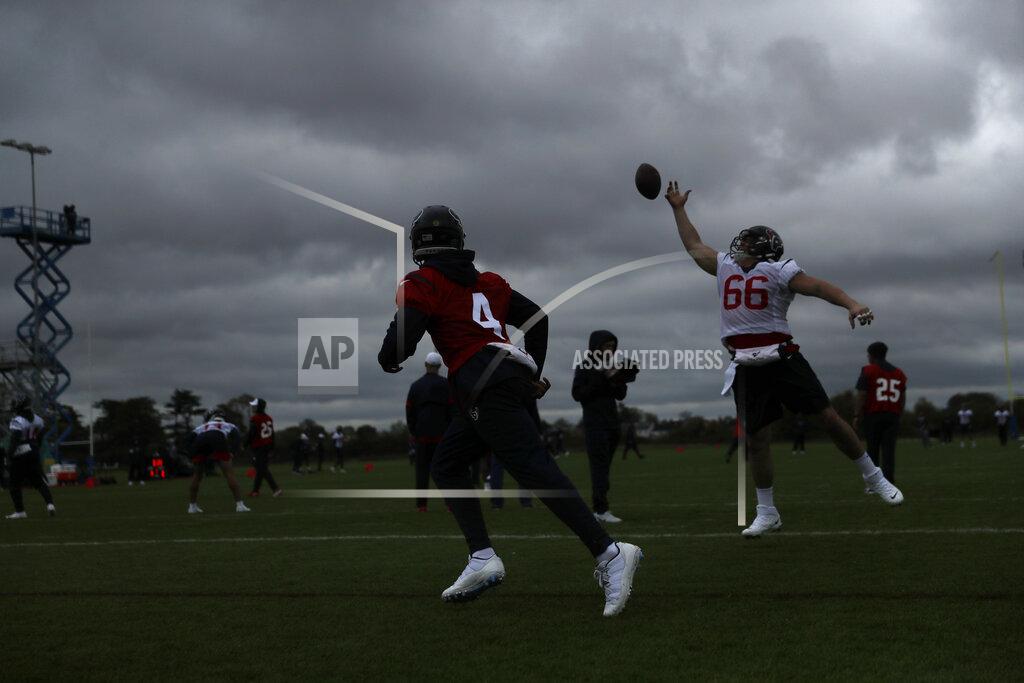 Matt Dunham Houston Texans' center Nick Martin, 66, tries to catch a ball from quarterback Deshaun Watson, 4, during an NFL practice session at the London Irish rugby team training ground in the Sunbury-on-Thames suburb of south west London, Friday, Nov. 1, 2019. The Houston Texans are preparing for an NFL regular season game against the Jacksonville Jaguars in London on Sunday. (AP Photo/Matt Dunham)