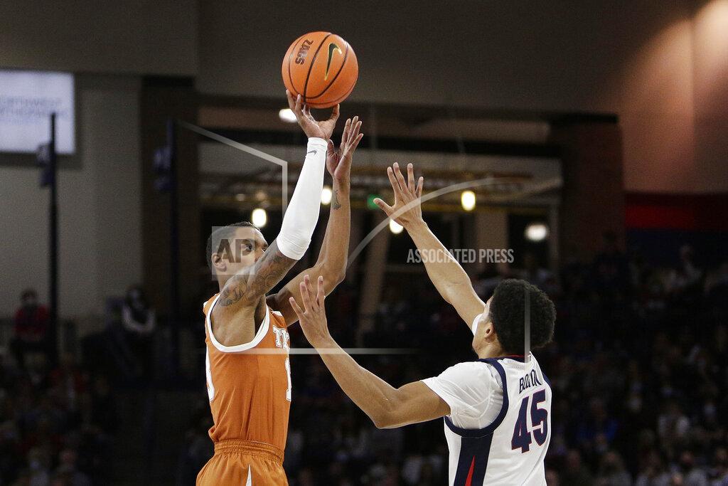 Young Kwak Texas guard Jase Febres, left, shoots while pressured by Gonzaga guard Rasir Bolton during the second half of an NCAA college basketball game, Saturday, Nov. 13, 2021, in Spokane, Wash. (AP Photo/Young Kwak)