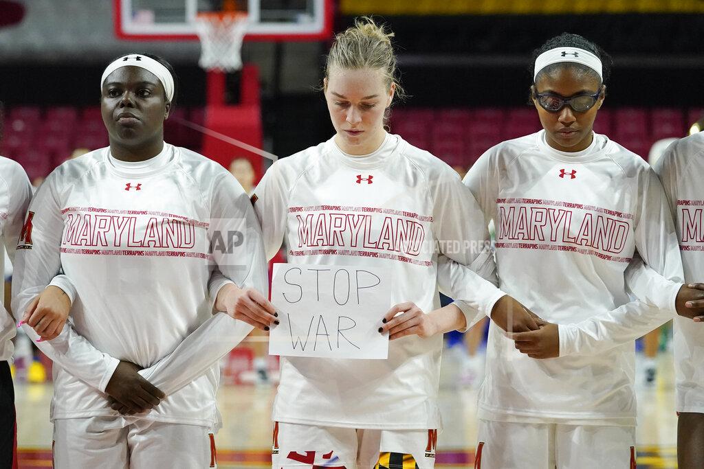Julio Cortez Maryland guard Taisiya Kozlova, center, holds a sign reading "No War" while standing with guard Ashley Owusu, left, and guard Shyanne Sellers, right, prior to a college basketball game against Florida Gulf Coast in the second round of the NCAA tournament, Sunday, March 20, 2022, in College Park, Md. (AP Photo/Julio Cortez)