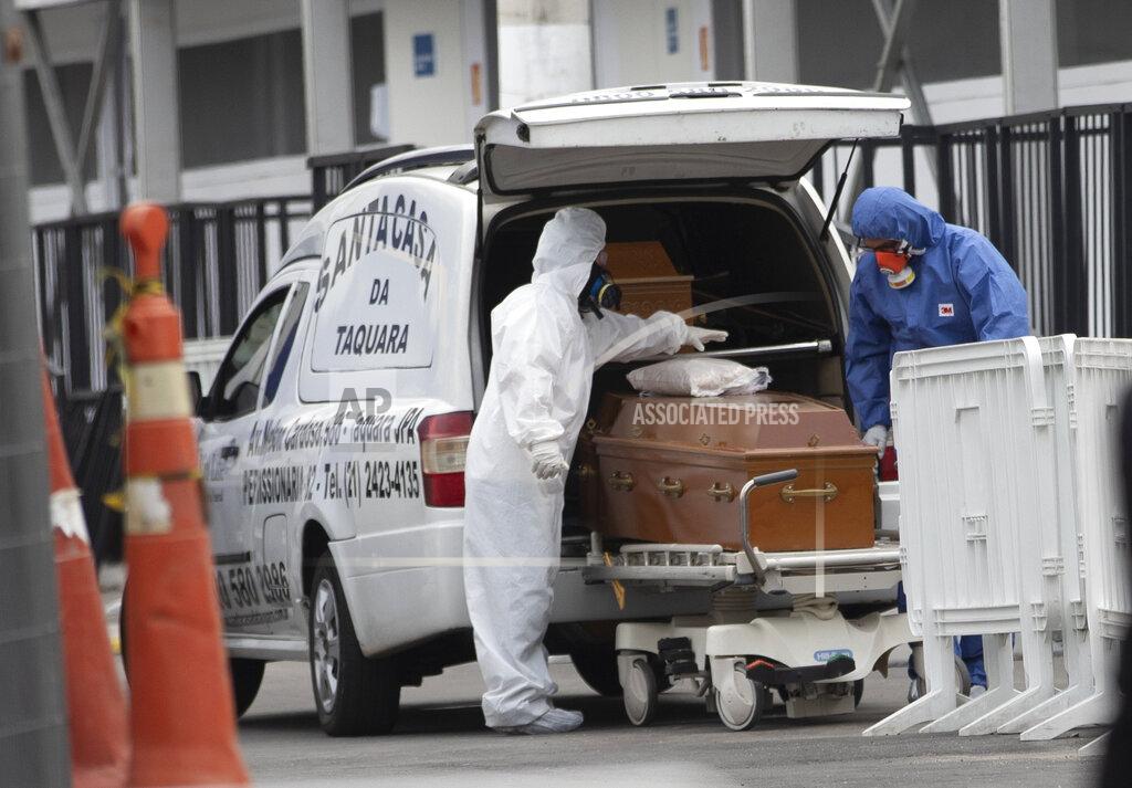 Silvia Izquierdo Funeral workers wearing protective gear as a precaution amid the new coronavirus pandemic push the remains of a COVID-19 victim into a funeral car at a field hospital in Leblon, Rio de Janeiro, Brazil, Thursday, June 4, 2020. (AP Photo/Silvia Izquierdo)