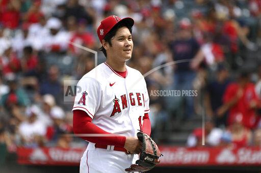 Los Angeles Angels pitcher Shohei Ohtani smiles after finishing the seventh inning of a baseball game against the Seattle Mariners, Sunday, Sept. 26, 2021, in Anaheim, Calif. The Mariners won 5-1. (AP Photo/Michael Owen Baker)