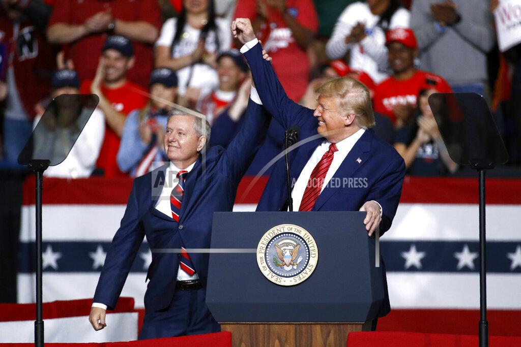 FILE - In this Feb. 28, 2020 file photo, Sen. Lindsey Graham, R-S.C., left, stands onstage with President Donald Trump during a campaign rally, in North Charleston, S.C. Jaime Harrison has raised more money than his Republican opponent, Sen. Lindsey Graham, two quarters in a row. (AP Photo/Patrick Semansky, File)