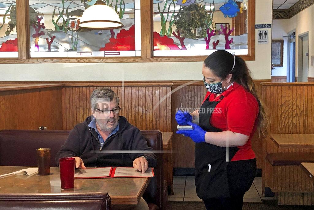 Sara Tewksbury This photo from KTVF-TV shows a diner ordering lunch at the Airport Way Family Restaurant in Fairbanks, Alaska, on Friday, April 24, 2020. Alaska businesses slowly began reopening Friday in an effort to restart the state's economy. The state's largest city, Anchorage, will allow businesses to reopen beginning Monday. (Sara Tewksbury/KTVF-TV via AP)