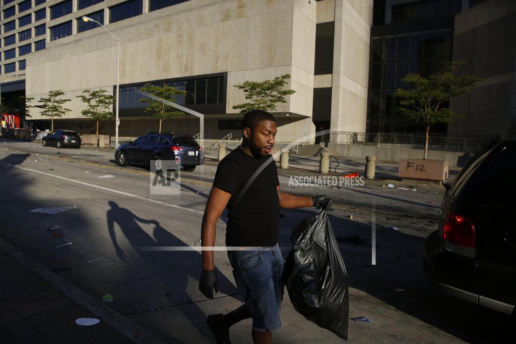 Brynn Anderson Bryan Booth, 27, of Atlanta, cleans the streets of downtown Atlanta in the aftermath of a demonstration against police violence on Saturday, May 30, 2020, in Atlanta. (AP Photo/Brynn Anderson)