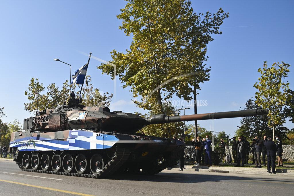 Giannis Papanikos A Tank depicting a paint of a Greek Flag parade through the streets of the northern port city of Thessaloniki, Greece, during a military parade, on Thursday, Oct. 28, 2021. The parade is held to celebrate Greece's refusal to align itself with a belligerent fascist Italy in 1940 and instead fight a much stronger opponent, a decision which dragged it into World War II and eventually led to a brutal occupation by Nazi Germany. (AP Photo/Giannis Papanikos)