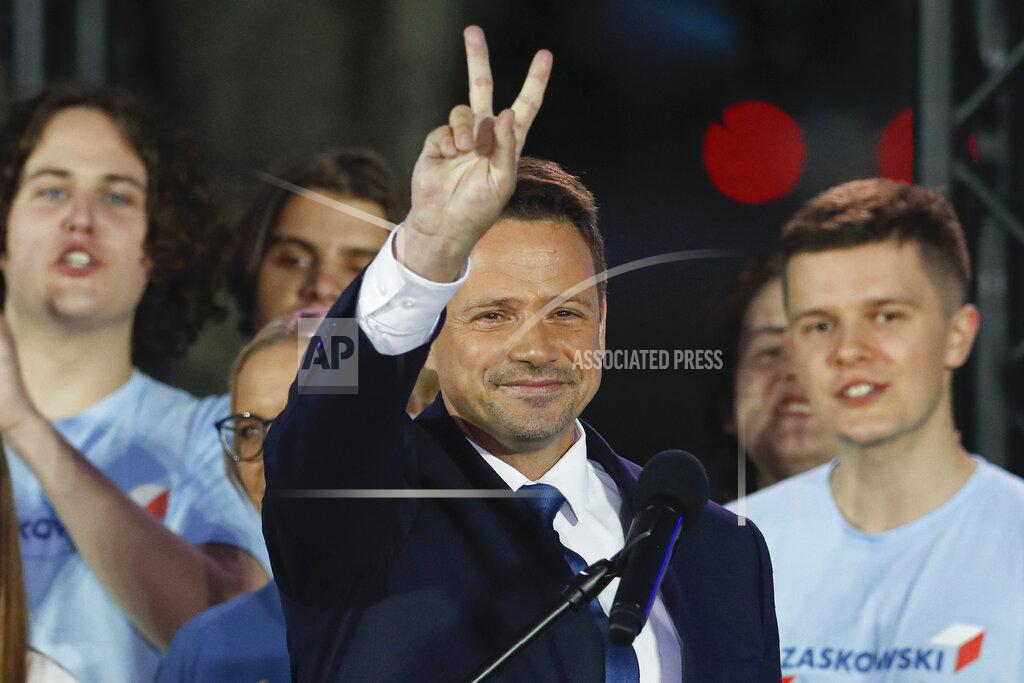 Petr David Josek Presidential candidate Rafal Trzaskowski flashes a victory sign at the end of the election day in Warsaw, Poland, Sunday, July 12, 2020. Voting ended in Poland's razor-blade-close presidential election runoff between the conservative incumbent Andrzej Duda and liberal, pro-European Union Warsaw Mayor Rafal Trzaskowski with exit polls showing the election is too close to call. (AP Photo/Petr David Josek)