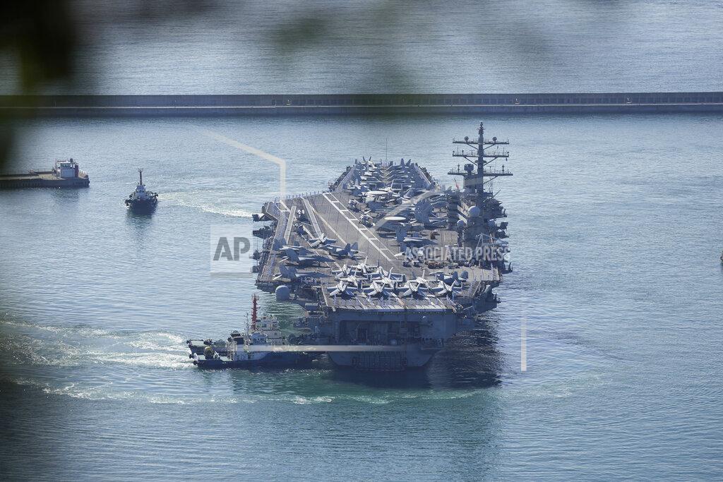 Lee Jin-Man U.S. aircraft carrier USS Ronald Reagan is escorted into Busan Naval Base in Busan, South Korea, Friday, Sept. 23, 2022. The USS Ronald Reagan arrived to participate in upcoming joint military drills with South Korea in the East Sea – the first time since 2017. (AP Photo/Lee Jin-man)