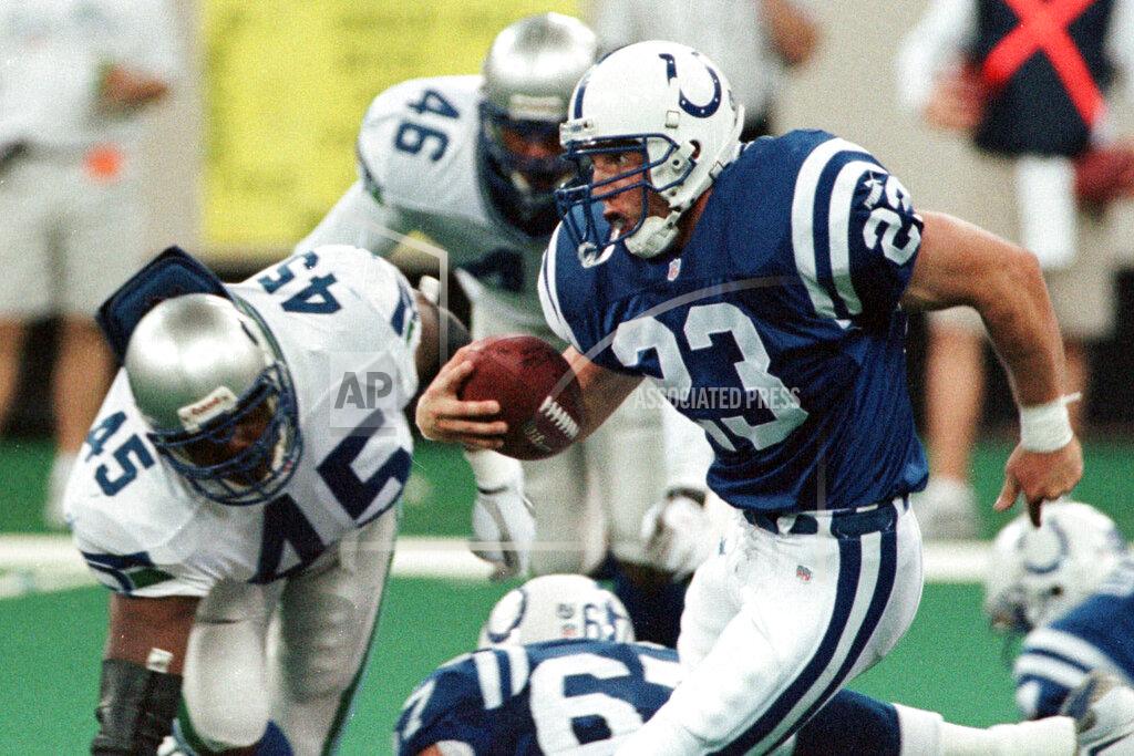 John Harrell FILE - In this Sept. 2, 1999, file photo, Indianapolis Colts running back Keith Elias (23) runs by Seattle Seahawks' Sedrick Clark (45) and Scott Fields (46) to pick up a first down on the Colts' final drive of an NFL football game in Indianapolis. Elias’ dad never played football because he was too small but he influenced the way his son approached the game. Elias spent five seasons in the league as a running back with the Giants and Colts from 1994-99. (AP Photo/John Harrell, File)