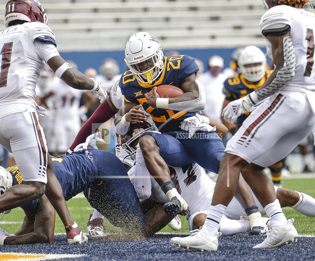 William Wotring West Virginia running back Alec Sinkfield (20) rushes for a touchdown against Eastern Kentucky during an NCAA college football game on Saturday, Sept. 12, 2020, in Morgantown, W.Va. (William Wotring/The Dominion-Post via AP)
