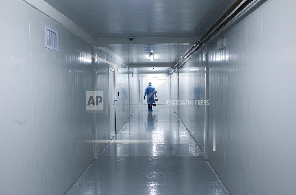 Arnulfo Franco FILE - In this April 16, 2020, file photo, a worker wearing protective gear walks down the corridor of a new health facility that will take in patients infected with the new coronavirus, during a media presentation in Panama City. Even amid a global pandemic, there’s no sign that corruption is slowing down in Latin America. From Argentina to Panama, a number of officials have been forced to resign as reports of possibly fraudulent purchases of ventilators, masks and medical supplies proliferate. (AP Photo/Arnulfo Franco, File)