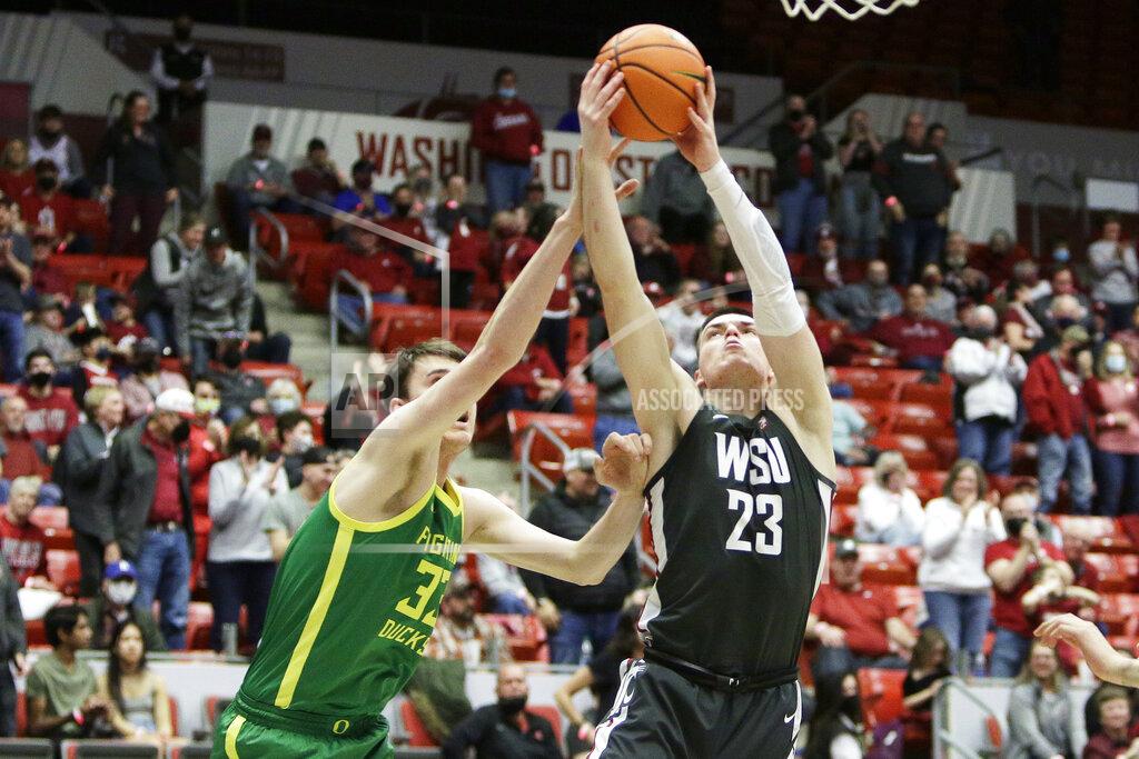 Young Kwak Oregon center Isaac Johnson (33) and Washington State forward Andrej Jakimovski (23) go after a rebound during the second half of an NCAA college basketball game, Saturday, March 5, 2022, in Pullman, Wash. Washington State won 94-74. (AP Photo/Young Kwak)