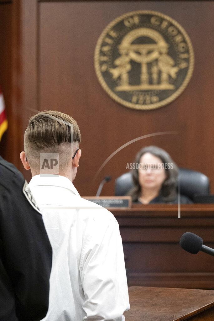 Ben Gray Robert Aaron Long stands before Judge Ellen McElyea in Superior Court of Cherokee County in Canton, Ga. on Tuesday, July 27, 2021. The man accused of killing eight people, most of them women of Asian descent, at Atlanta-area massage businesses pleaded guilty to four of the murders. He was handed four sentences of life without parole. Robert Aaron Long still faces the death penalty in the four other deaths, which are being prosecuted in a different county. (Ben Gray/Atlanta Journal-Constitution via AP, Pool)