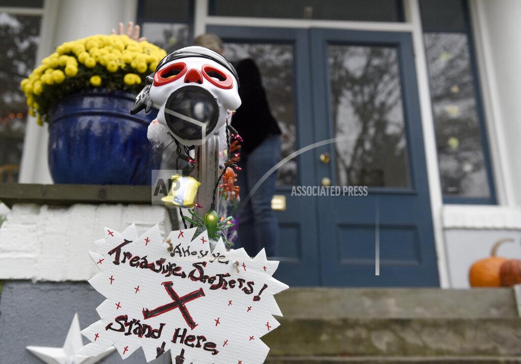 Michael Perez Carol McCarthy sends candy down the candy chute that she will use to give out treats to socially-distant trick-or-treaters on Halloween, Monday, Oct. 26, 2020, in Palmyra, N.J. (AP Photo/Michael Perez)