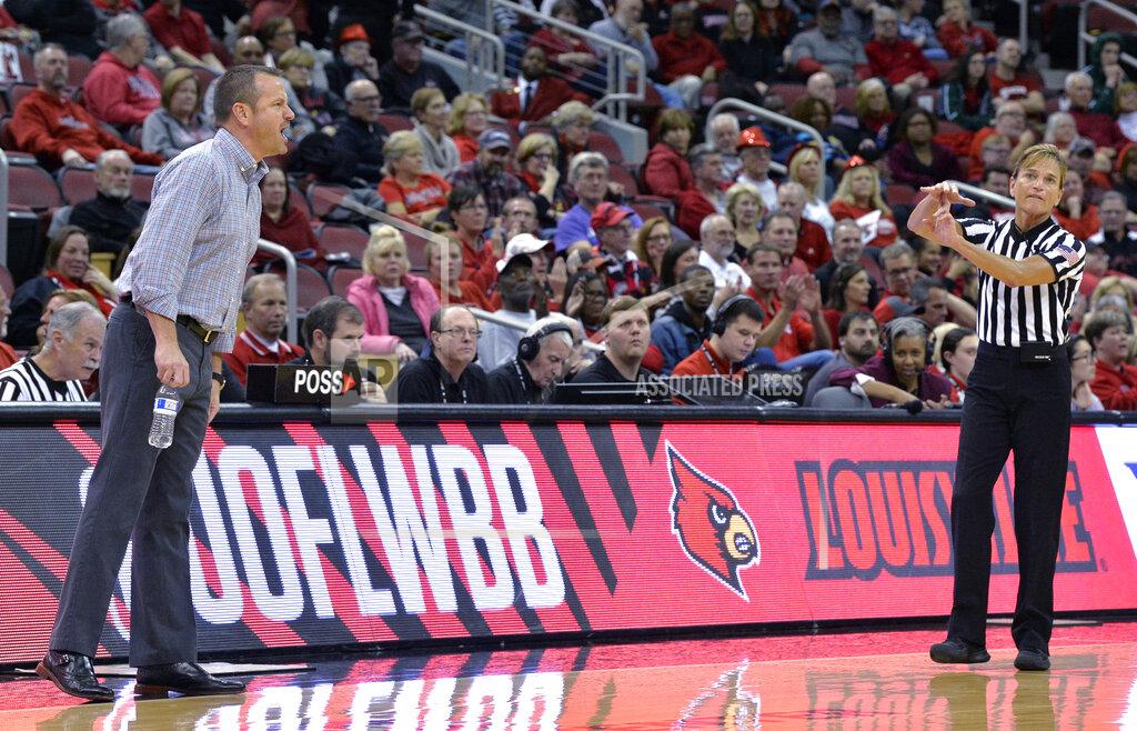 Timothy D. Easley FILE - Referee Dee Kantner gives Louisville coach Jeff Walz a technical foul during the second half of the team's NCAA college basketball game against Nebraska in Louisville, Ky., Thursday, Nov. 29, 2018. Louisville won 85-68. Kantner, a veteran referee of women’s games who works for multiple conferences, finds it frustrating to have to justify equal pay. “If I buy an airline ticket and tell them I’m doing a women’s basketball game they aren’t going to charge me less,” she said. (AP Photo/Timothy D. Easley, File)