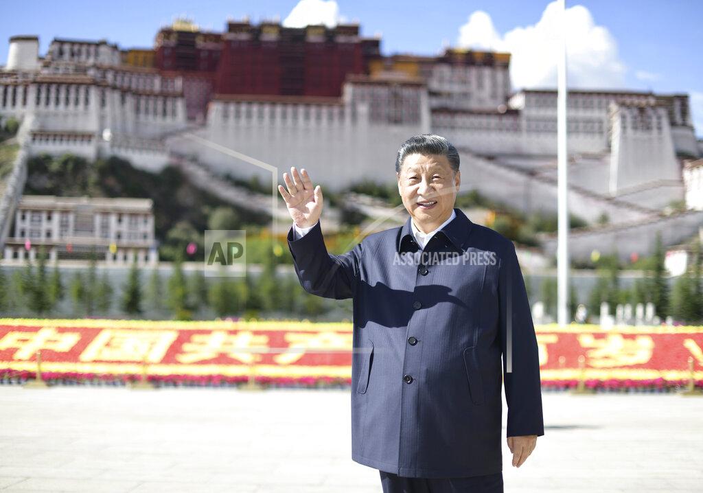 Xie Huanchi In this July 22, 2021 photo released by China's Xinhua News Agency, Chinese President Xi Jinping waves while visiting a public square below the Potala Palace in Lhasa in western China's Tibet Autonomous Region. Chinese leader Xi Jinping has made a rare visit to Tibet as authorities tighten controls over the Himalayan region's traditional Buddhist culture, accompanied by an accelerated drive for economic development. (Xie Huanchi/Xinhua via AP)
