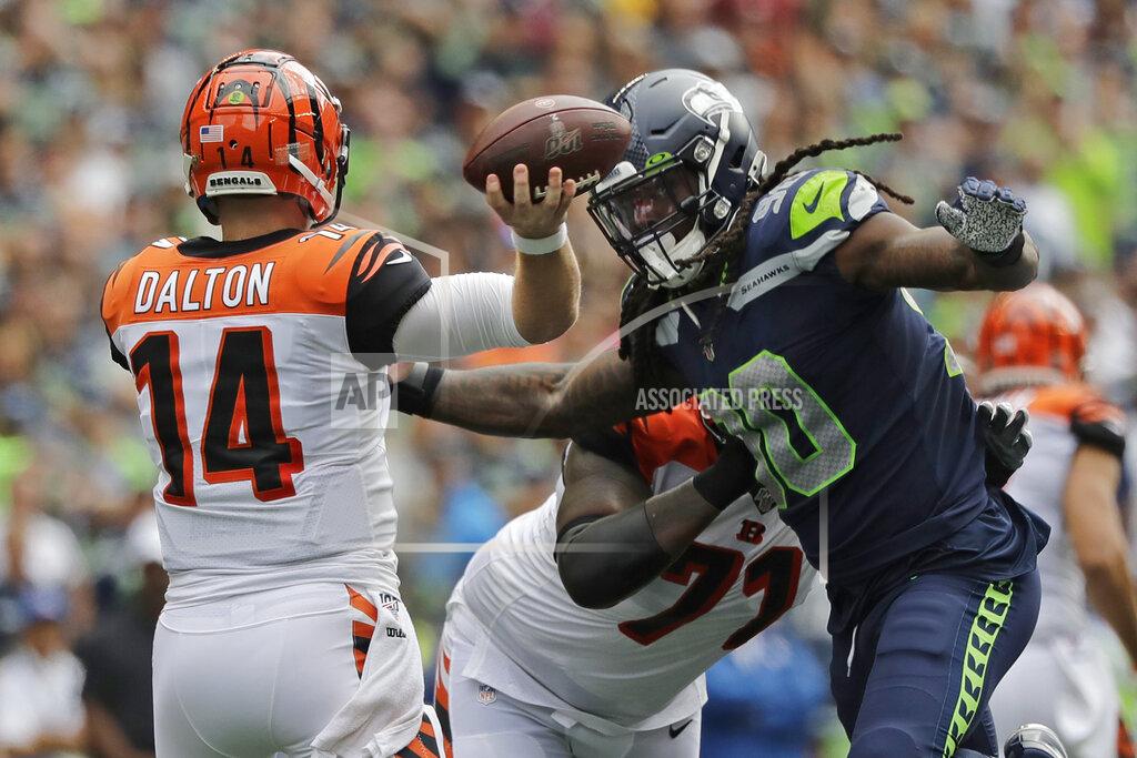 John Froschauer Cincinnati Bengals quarterback Andy Dalton (14) passes under pressure from Seattle Seahawks defensive end Jadeveon Clowney, right, for a touchdown to wide receiver John Ross (not shown) during the first half of an NFL football game, Sunday, Sept. 8, 2019, in Seattle. (AP Photo/John Froschauer)