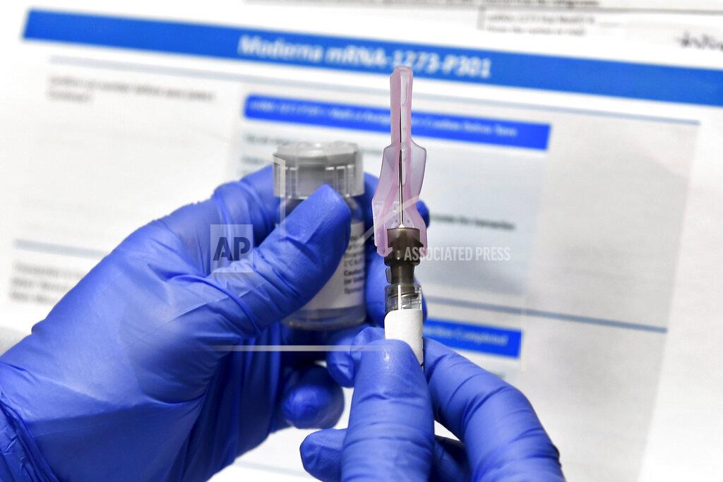 FILE - In this Monday, July 27, 2020 file photo, a nurse prepares a shot as a study of a possible COVID-19 vaccine, developed by the National Institutes of Health and Moderna Inc., gets underway in Binghamton, N.Y. Who gets to be first in line for a COVID-19 vaccine? U.S. health authorities hope by late next month to have some draft guidance on how to ration initial doses, but it’s a vexing decision. (AP Photo/Hans Pennink)