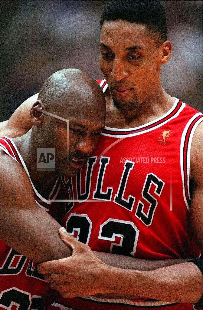 Jack Smith FILE - In this June 11, 1997 file photo, Chicago Bulls Scottie Pippen, right, embraces an exhausted Michael Jordan following their win in Game 5 of the NBA Finals against the Utah Jazz, in Salt Lake City. The flu-like illness Jordan fought through to lead the Bulls to a crucial victory in the 1997 NBA Finals created instant fodder for the virtue of perseverance. Pushing past boundaries, overcoming obstacles and adversity — that is part of the ethos of major competitive sports. That is how elite athletes become wired to win. (AP Photo/Jack Smith, File)