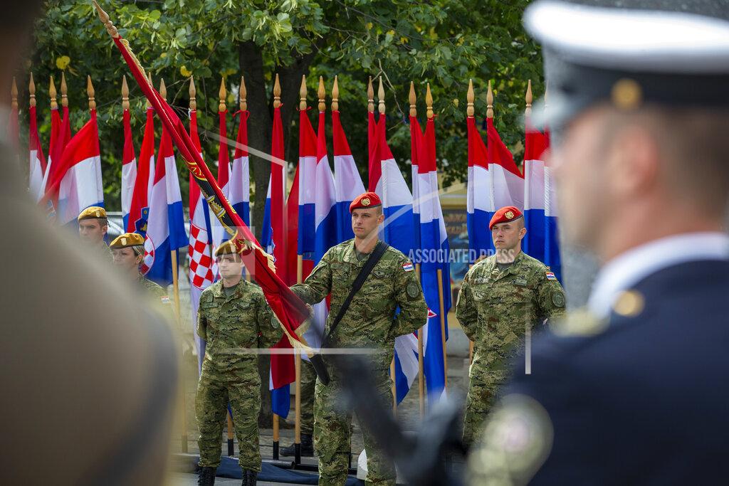 Darko Bandic Croatian soldiers attend a ceremony in Knin, Croatia, Wednesday, Aug. 5, 2020. Croatia marked the 25th anniversary of a victorious wartime military offensive, with an ethnic Serb politician attending the ceremony for the first time in what is seen as an important step toward reconciliation. (AP Photo/Darko Bandic)