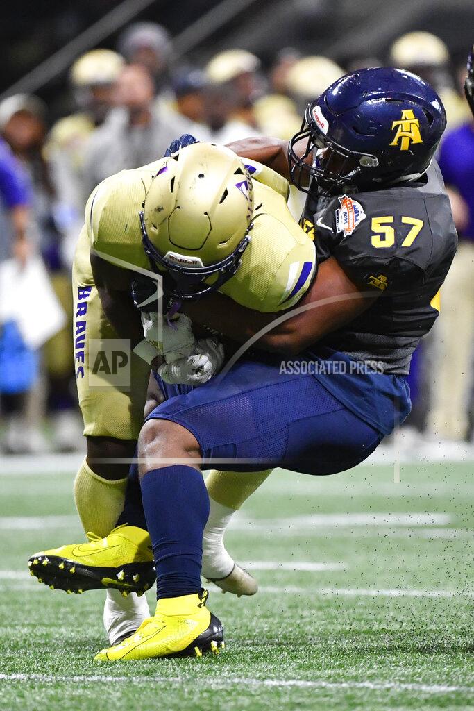 John Amis North Carolina A&T linebacker Jacob Roberts (57) brings down Alcorn State tight end Jerimiah Green during the first half of the Celebration Bowl NCAA college football game, Saturday, Dec. 21, 2019, in Atlanta. (John Amis/Atlanta Journal-Constitution via AP)