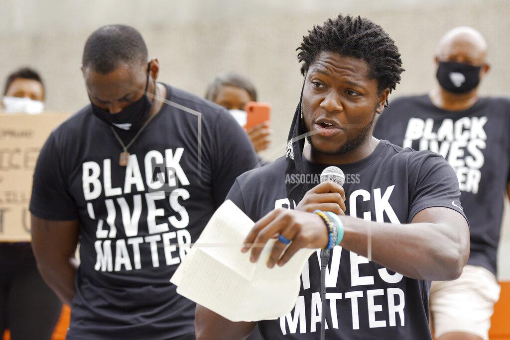 Bob Self FILE - In this June 5, 2020, file photo, Jacksonville Jaguars football player Chris Conley addresses the crowd of teammates, staff and families on the steps of the Jacksonville Sheriff's Office headquarters building in Jacksonville, Fla., as they protest against inequality and police brutality. Conley is calling on “figures who are the face of the league” to do more to help fight social injustice. The sixth-year pro made it clear Thursday, Aug 27, he was talking about the NFL’s top quarterbacks, the ones who have the most influence in games, in locker rooms and in communities. Think Tom Brady, Drew Brees, Patrick Mahomes, Deshaun Watson, Russell Wilson and Lamar Jackson, for starters. (Bob Self/The Florida Times-Union via AP File)