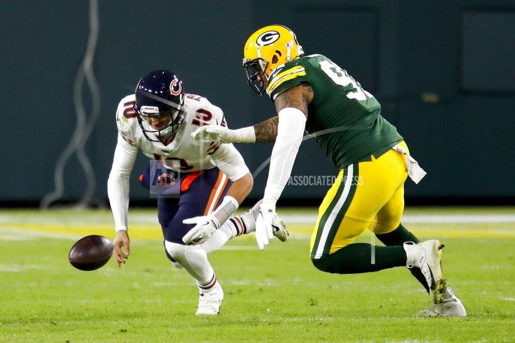 Chicago Bears' Mitchell Trubisky recovers his own fumble in front of Green Bay Packers' Preston Smith during the second half of an NFL football game Sunday, Nov. 29, 2020, in Green Bay, Wis. (AP Photo/Matt Ludtke)