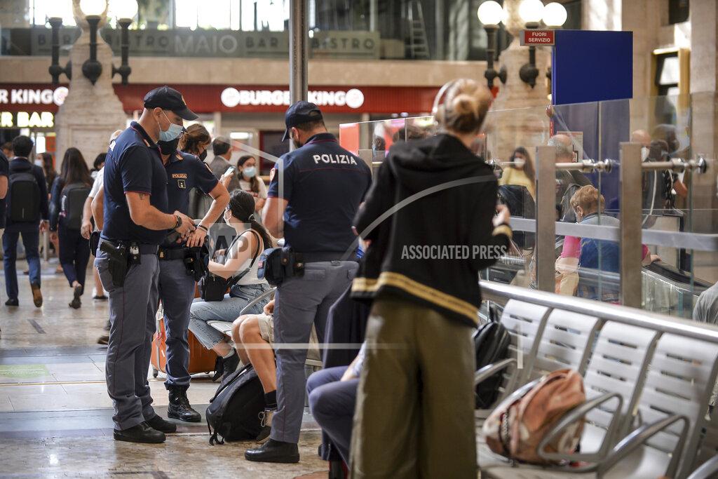 Claudio Furlan Italian police officers perform checks at Milan's Stazione Centrale train station, Italy, Wednesday, Sept. 1, 2021. The Italian government vowed to crack down on demonstrators threatening to block train tracks throughout the country on Wednesday as a rule requiring COVID-19 tests or vaccines takes effect for long-distance domestic public transport. (Claudio Furlan/LaPresse via AP)